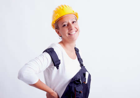 Female construction worker with tools on white の写真素材