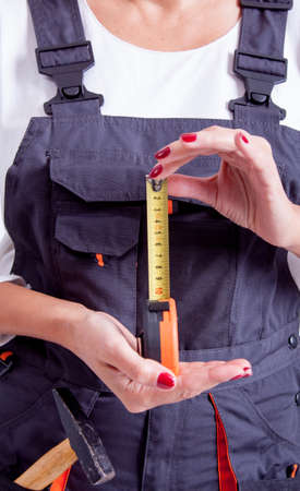 Female construction worker with tools on white の写真素材