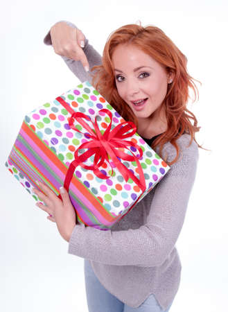 Woman holding gift box on white backgroundの写真素材