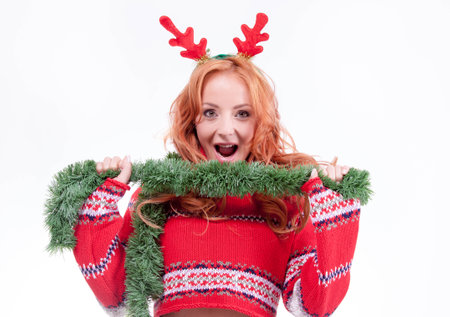 Beautiful woman with horns and christmas decorationsの写真素材