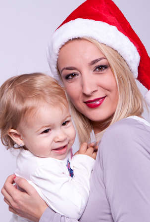Happy family mother and baby in Christmas hatの写真素材