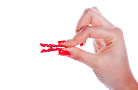 Beautiful woman hand holding clothes red peg