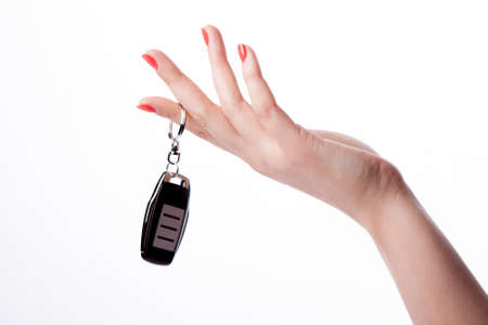 Beautiful woman hand holding remote control isolated on white backgroundの写真素材