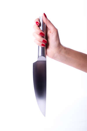 Woman hand with red manicure holding knifeの写真素材