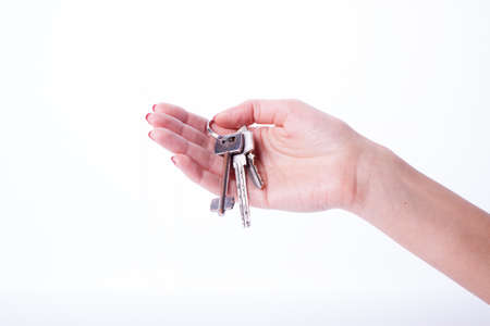 Woman hand  holding three keys for propertyの写真素材