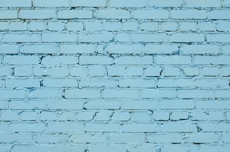 Texture of an old light blue brick wall.