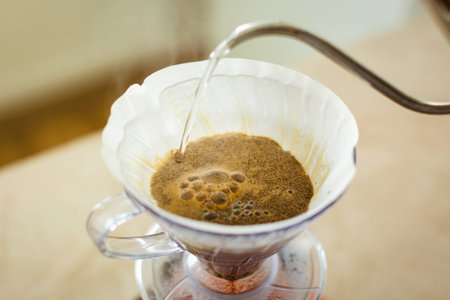 Close-up of a v60 drip pour over decanter, alternative method of brewing coffee. Air bubbles on the...