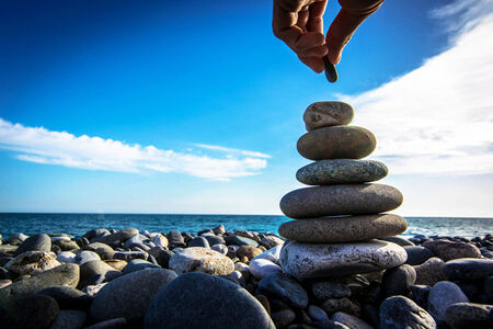Building a stone tower on a beach