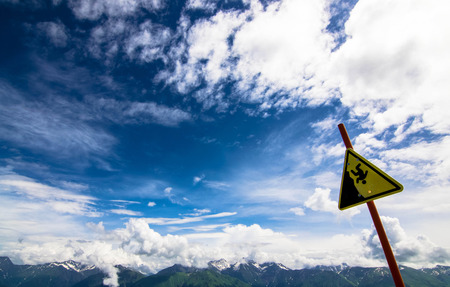 warning sign against a beautiful cloudscapeの写真素材
