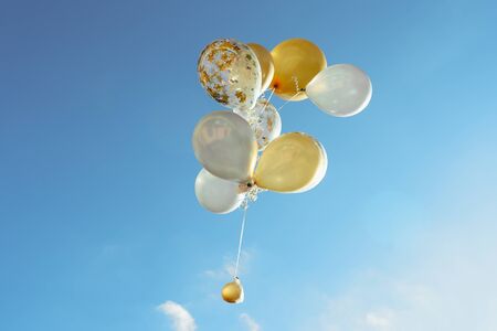 yellow and white transparent balloons blue clean skyの写真素材