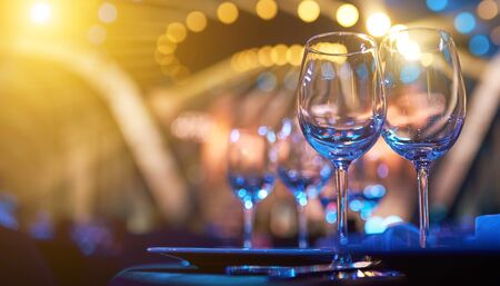 A glass of wine on table with colorful backlight