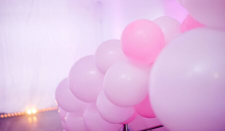 Lots of pink balls of different shades bound on railingsの写真素材