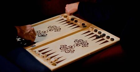 Senior couple playing classical backgammon, club eveningの写真素材
