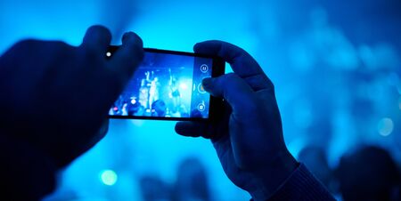 Someone talking a picture during a concert. High quality photoの写真素材