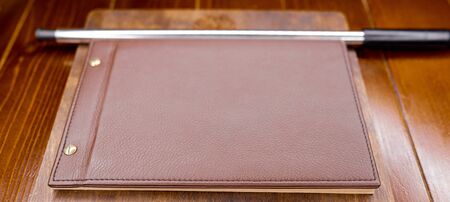 leather minu on a wooden basis with a hookah tubeの写真素材