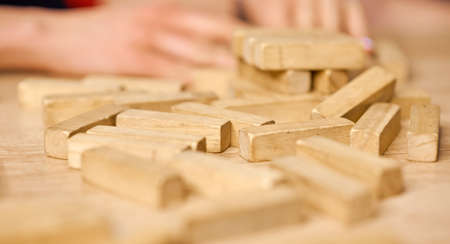 falling tower crumbled on a wooden table all over the surface