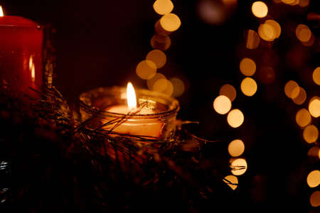 New Years candles in Christmas trees with beautiful sides in the background in the New Year and...