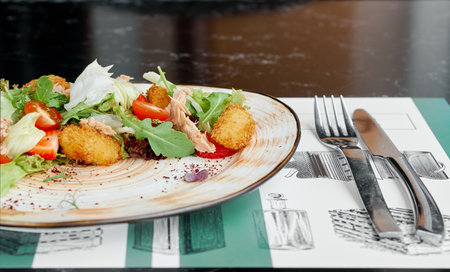 Side View of Salad with Tuna and Crispy Croquettes.