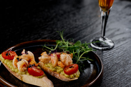 Close-Up Shrimp Crostini with Avocado Cream and Tomato.の写真素材
