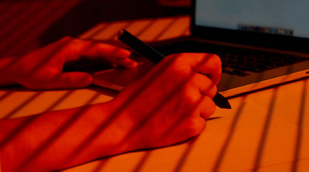 Woman Hand Drawing with Stylus Near Laptop Keyboard.の写真素材