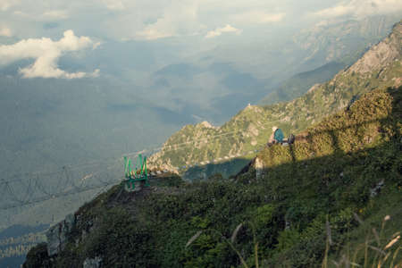 Landscape with mountains and clouds. Birds eye view. Early, Sunny morning. Sochi. Krasnaya Polyana.