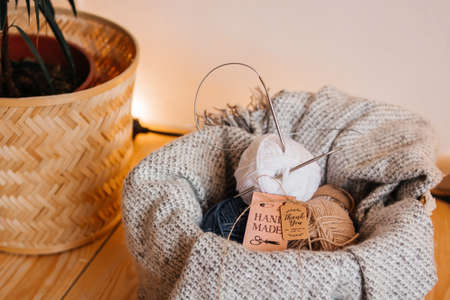 Balls of knitting thread in a basket with a blanket.の写真素材