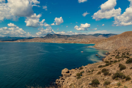 Seascape from the top of the mountains. The nature of the sea. Clouds, sea, mountains. A sunny day. Horizontal photo. Vacation, travel. Concept: calendar, cover.の写真素材