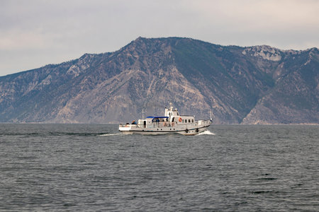 A tourist boat is moving along the coastline of Olkhon Island. Lake Baikal. High quality photosの写真素材
