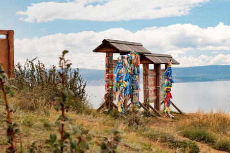 Prayer ribbons on sacred pillars on the island of Olkhon on a sunny summer day. A trip to Lake Baikal, domestic tourism in Russia.land. High quality photoの写真素材