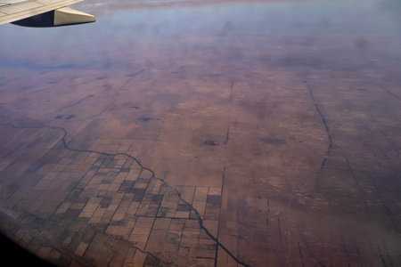 Awesome view of the Earth under the airplane wing. Amazing landscape is visible through airplane...