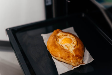 Khachapuri on baking paper is baked in the oven. We cook khachapuri with our own hands at home....