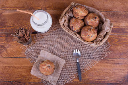 muffins with raisins and milk on the newspaperの写真素材