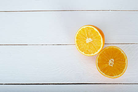 oranges and on a wooden borad on a white wooden backgroundの写真素材