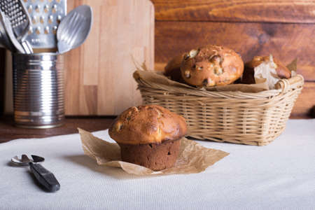 Fresh fruit muffin or cake with raisins on the wooden brown table background. Side view. selective focus.の写真素材