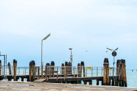Wooden jetty with seagulls in the sea.の写真素材