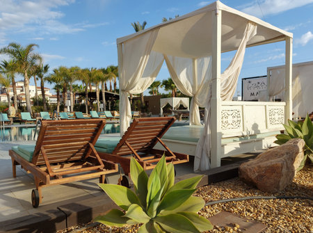 Wooden sunbeds and umbrellas on the beach.の写真素材