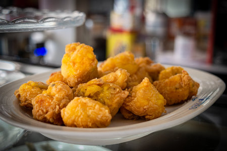 Deep-fried chicken nuggets on a plate in a restaurant.の写真素材