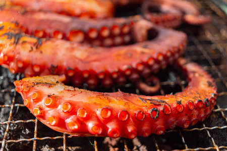 Grilled octopus on barbecue grill. Closeup of seafood.の写真素材
