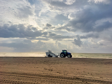 Tractor working on the beach at sunset, Sri Lanka, Asiaの写真素材