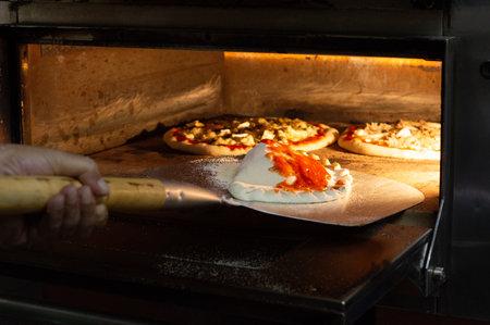 Cooking pizza in the oven. Preparation for baking pizza.の写真素材