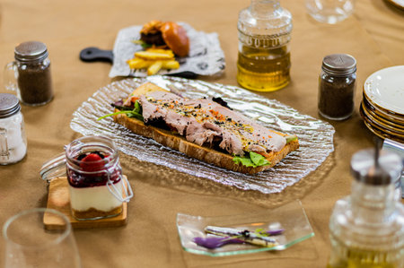 Canape with meat and vegetables on a tablecloth. Restaurant.の写真素材
