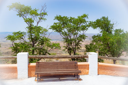 Wooden bench on terrace of villa with beautiful landscape viewの写真素材