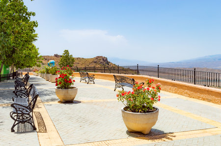 Beautiful terrace with flowers on the background of the sea and mountainsの写真素材