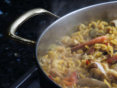 Image of paellera cooking fideuaの写真素材