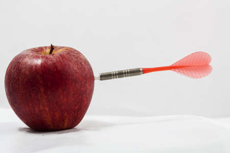 Image of apple with a dartの写真素材