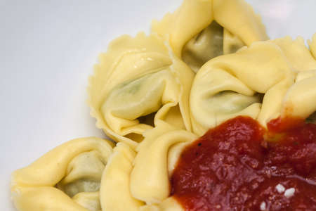 Tortellini with tomato sauce and parmesan cheeseの写真素材
