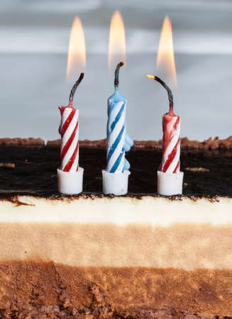 Birthday candles on chocolate cake の写真素材