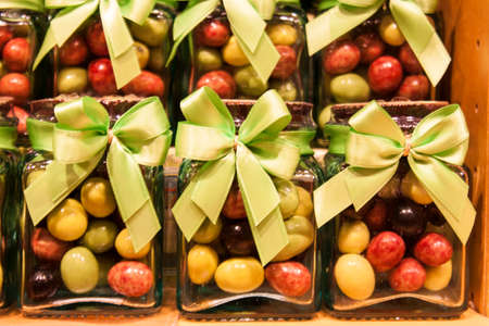 Colorful jars of candies with  ribbonの写真素材