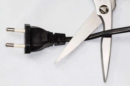 scissors cutting electric plug cableの写真素材