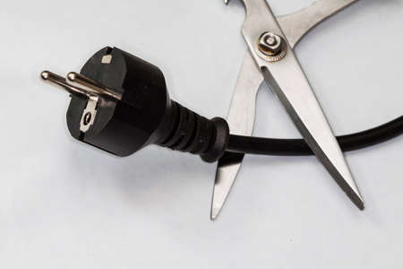 scissors cutting electric plug cableの写真素材